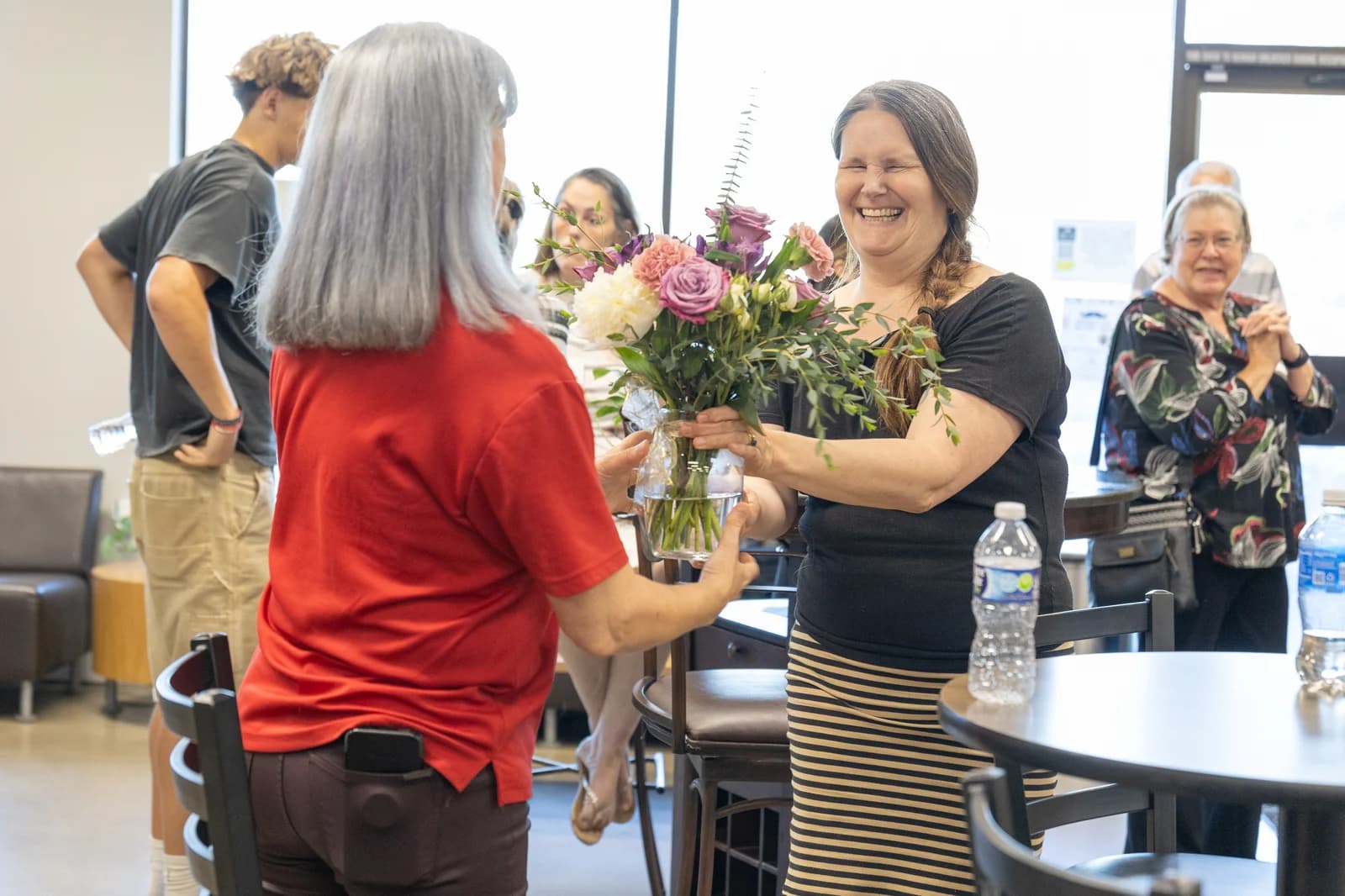 A guest laughing during a flower exchange at New Life Networking
